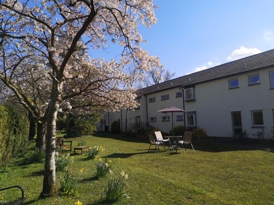 Sunny garden where residents can relax at Abbeyfield House
